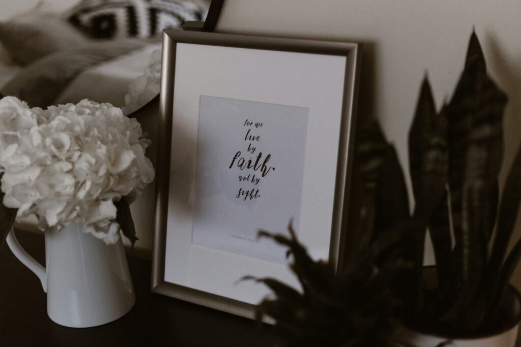 Frame on table with words for we live by faith not by sight