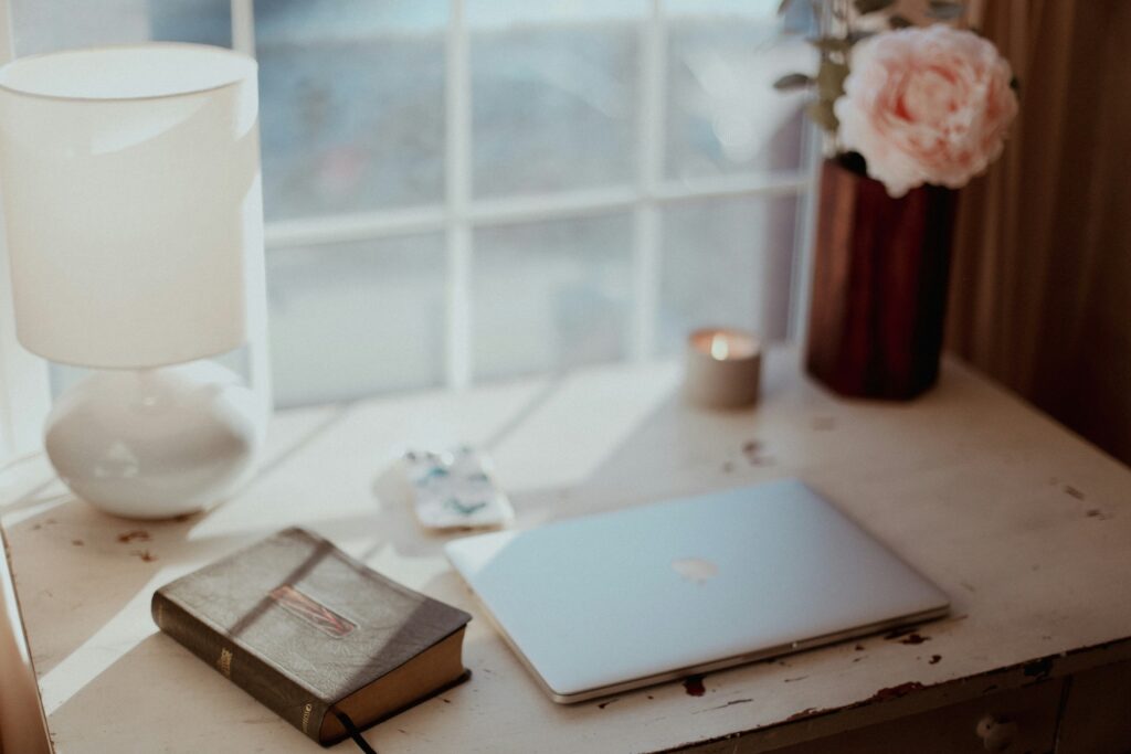 Laptop and Bible on desk